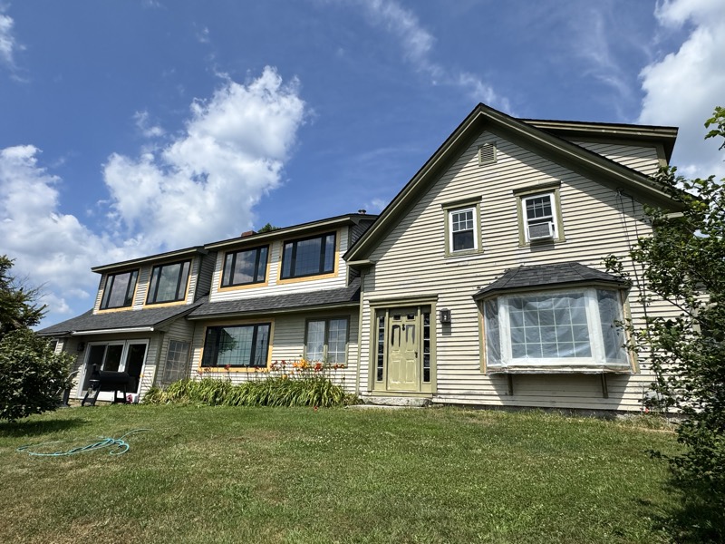 Two-story home with a bay window after exterior painting