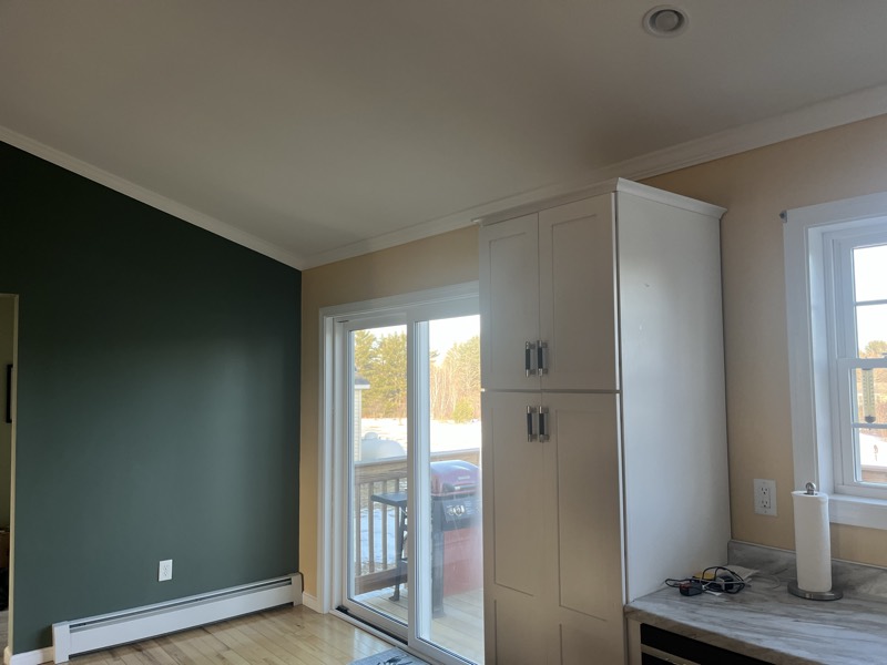 Room with deep green walls and white trim