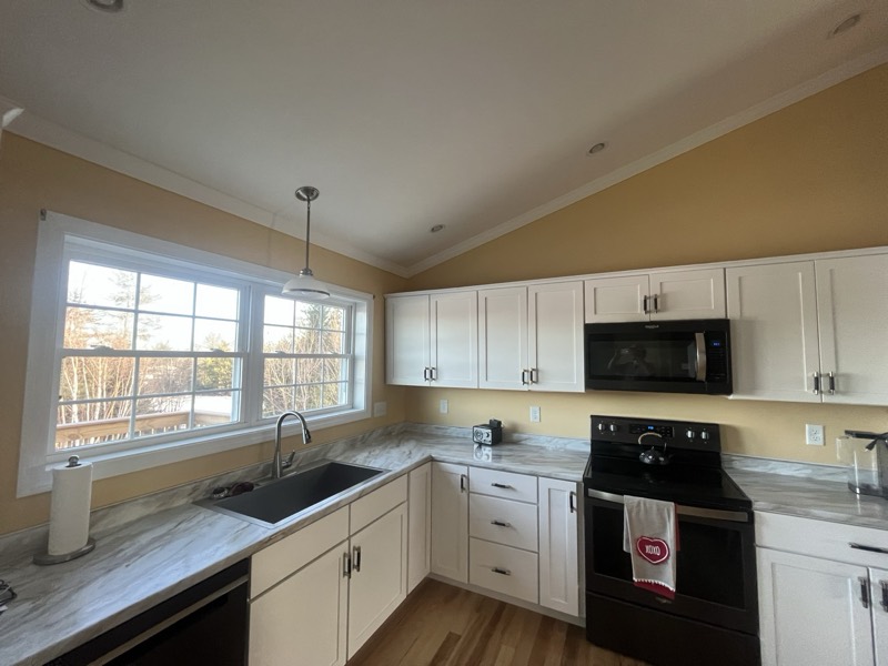 Bright kitchen with white cabinets and freshly painted walls