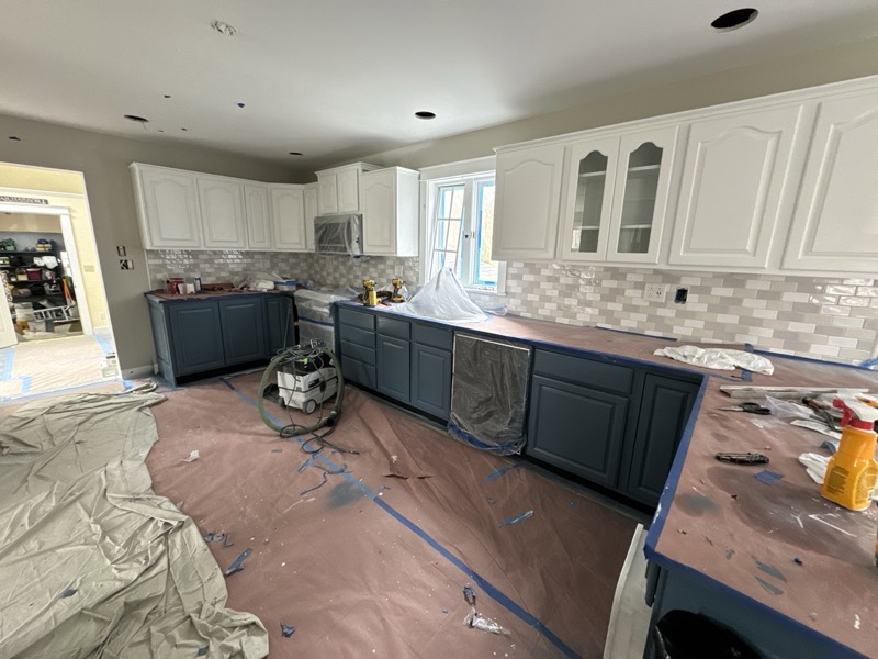Kitchen with refinished white upper and navy lower cabinets
