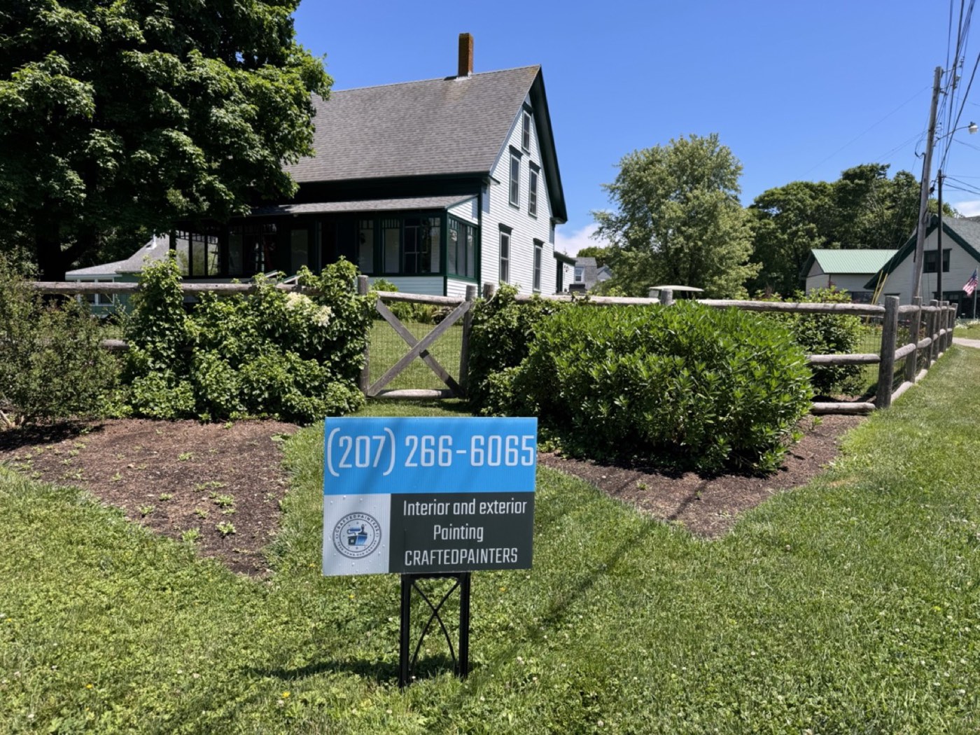 Crafted Painters yard sign outside a finished exterior painting job